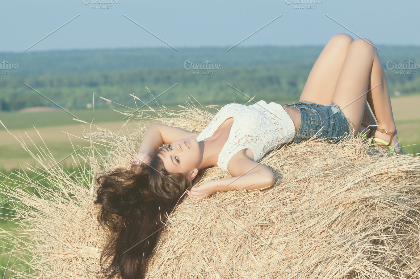 girl posing on a haystack  People Images ~ Creative Market