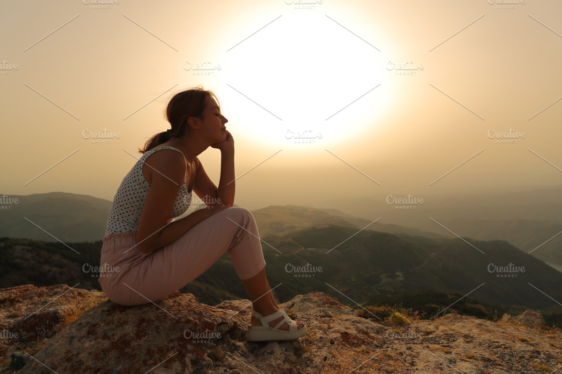 Woman relaxing at susnet in the mountain | Nature Stock Photos