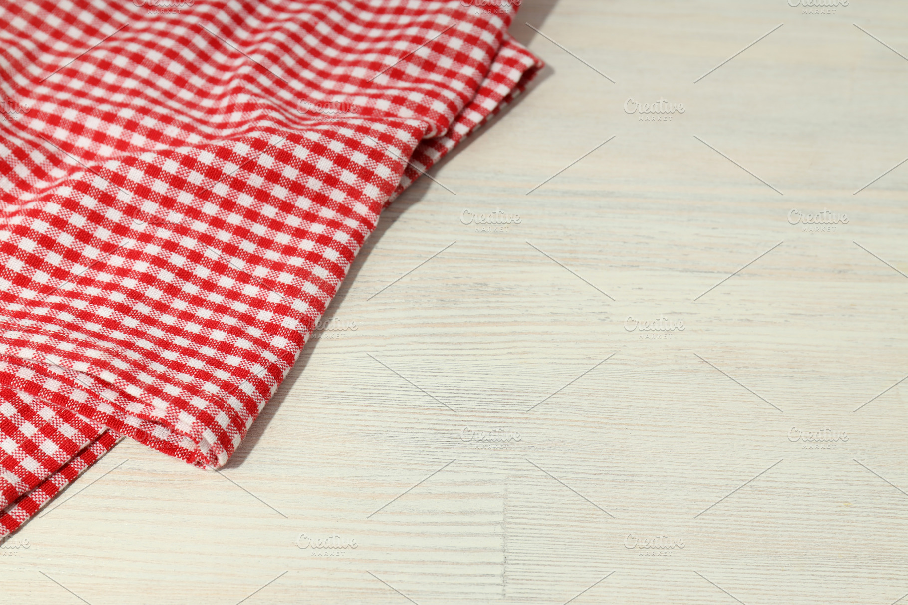 Red and white checkered tablecloth on wooden background | Food Images