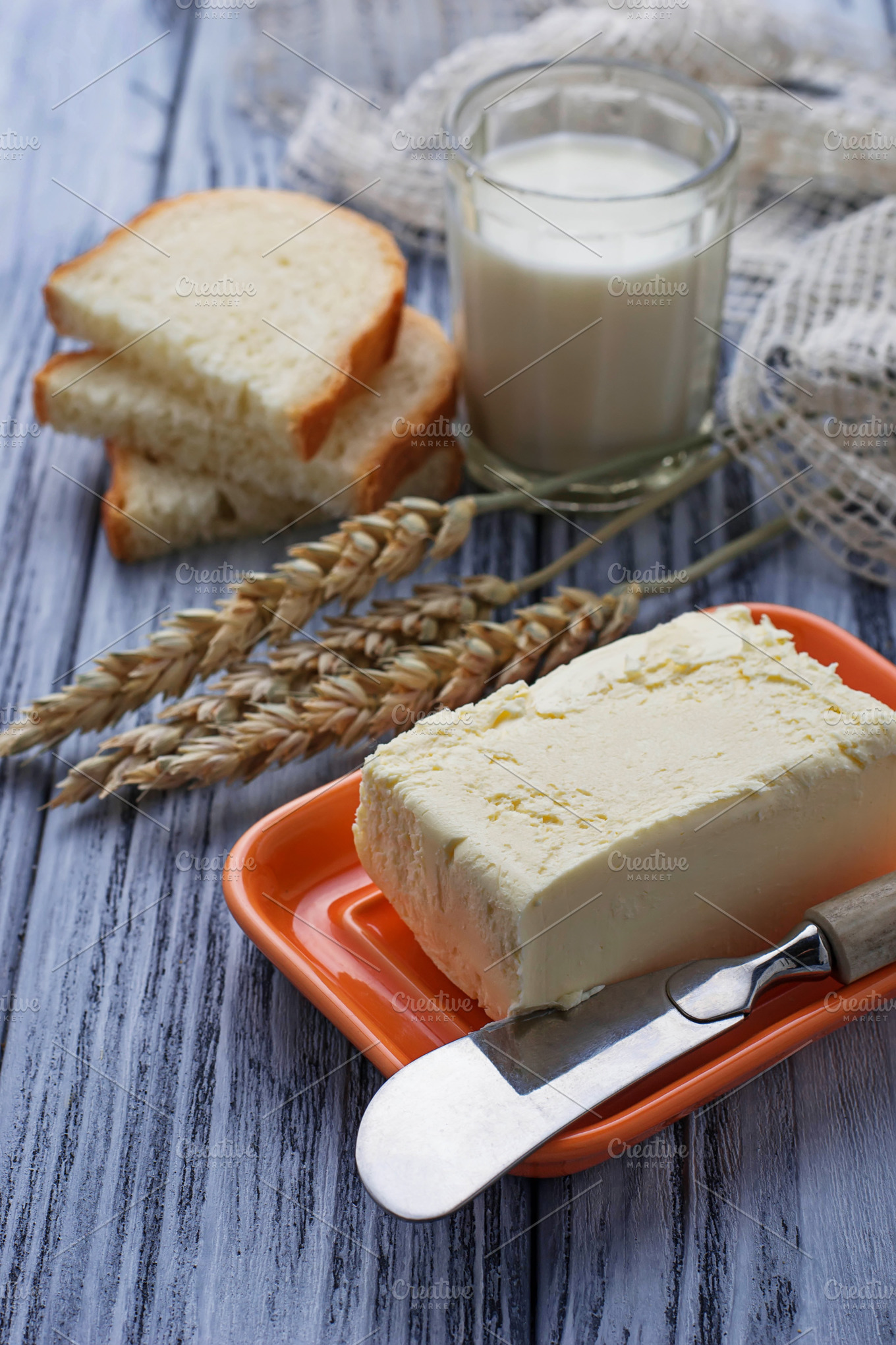 Glass of milk bread and butter containing background, bread, and