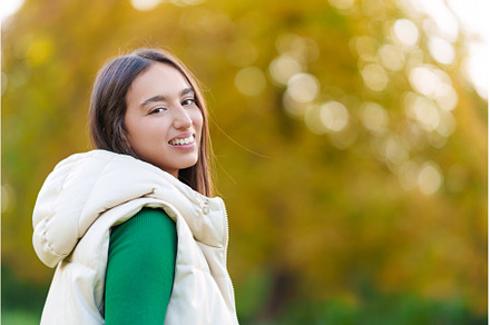 Fashion woman in trendy autumn outfit posing outdoor near see