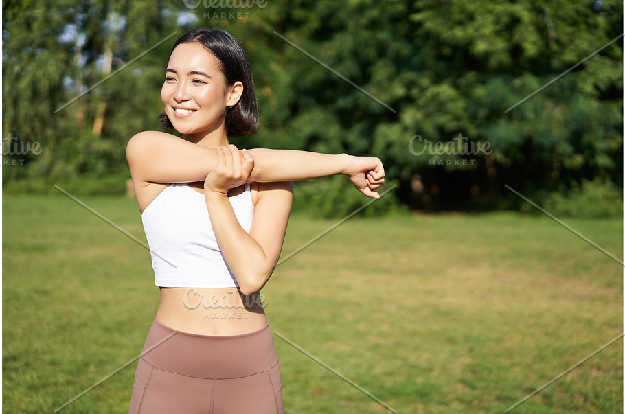 Asian woman stretching her arms  Sports & Recreation Stock Photos ~  Creative Market