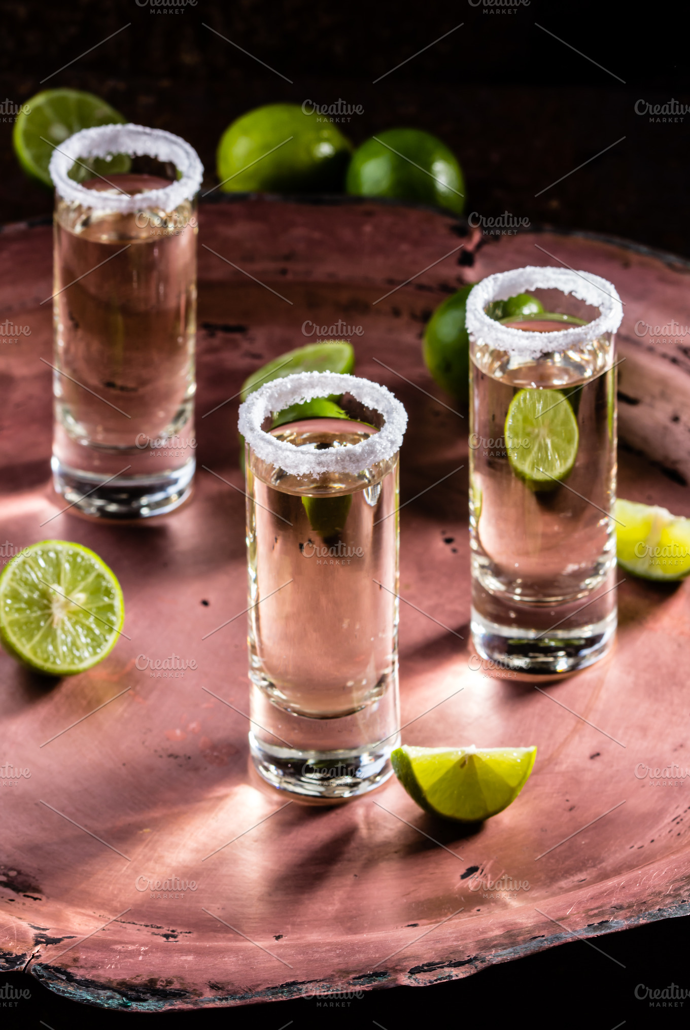 Tequila shot with lime and salt selective focus containing tequila ...