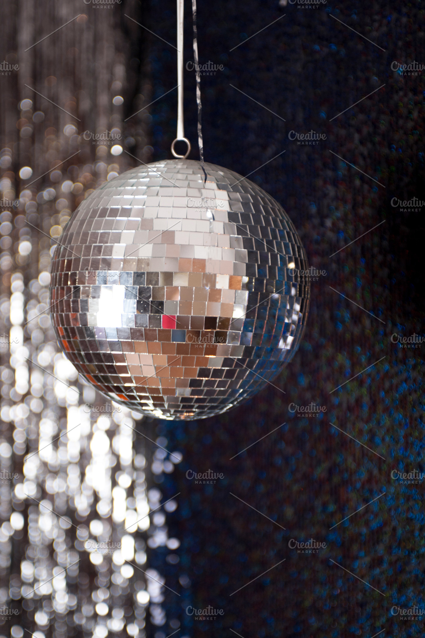 Mirror disco ball hanging from the ceiling stock photo containing disco