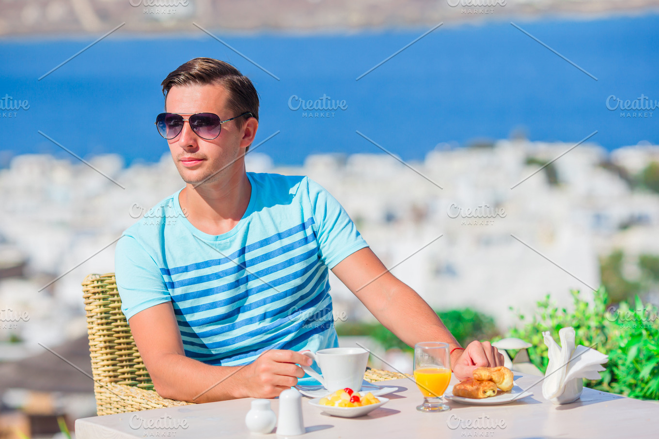 Young Boy Having Breakfast At Outdoor Cafe With Amazing View On Mykonos Town High Quality People Images Creative Market