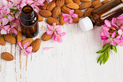 Background with almond oil almonds and flowers containing almond, oil