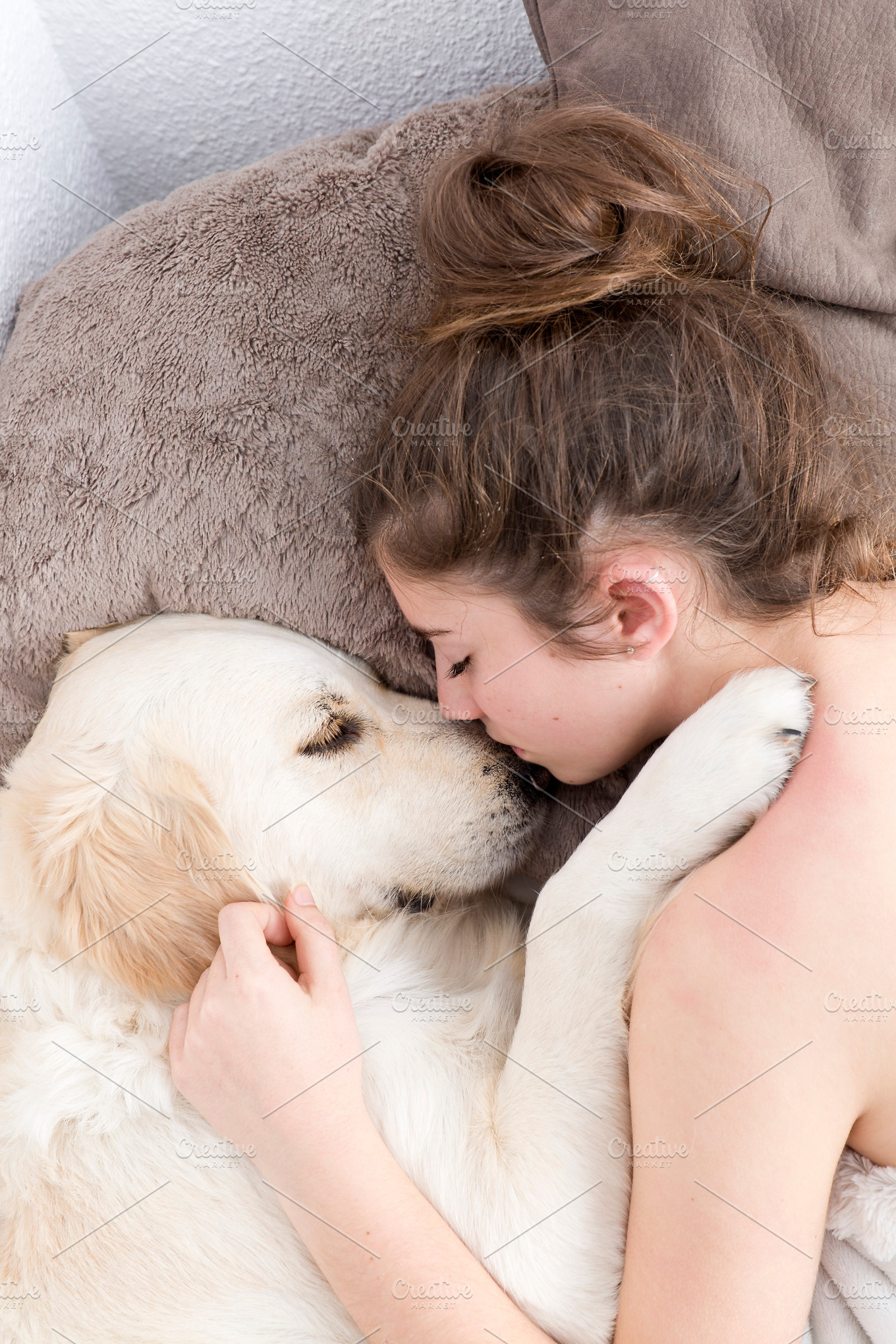 Teenage girl sleeping with her dog featuring animal, bed, and break