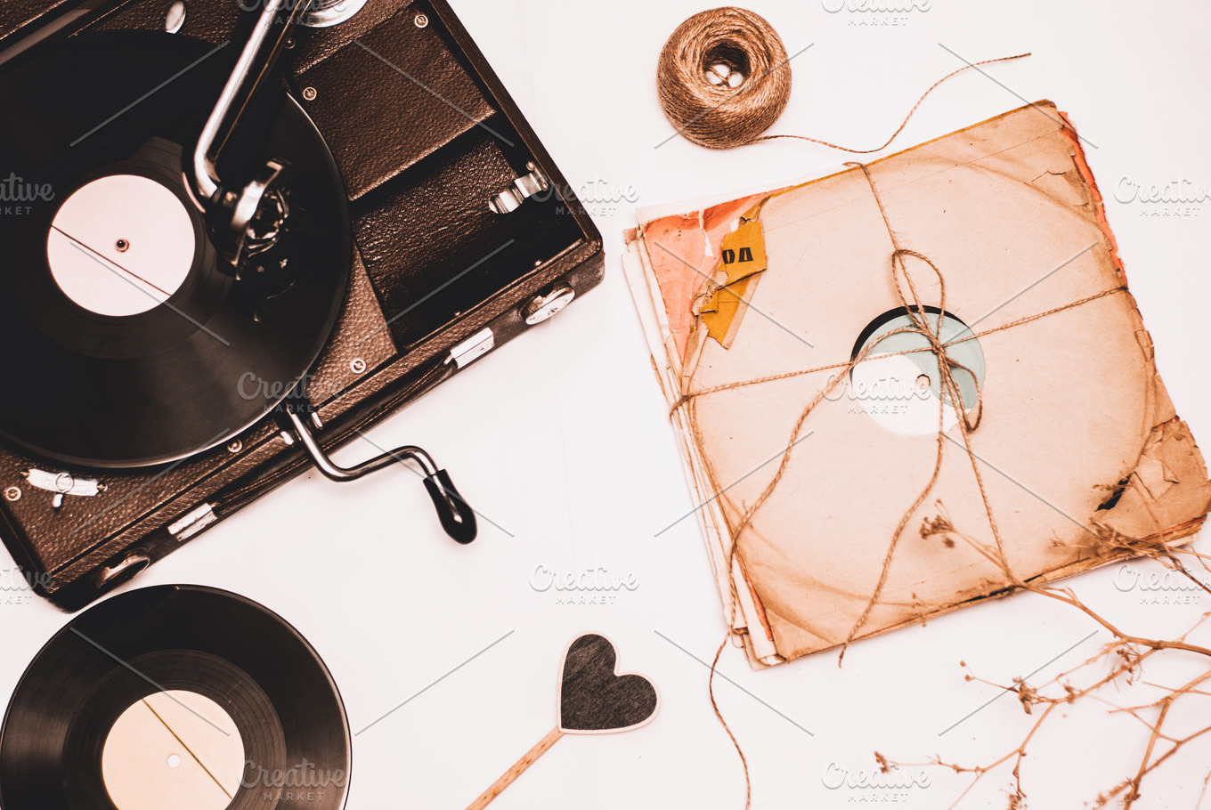 Stack of scratched dusty old vinyl records tied with rope on white ...