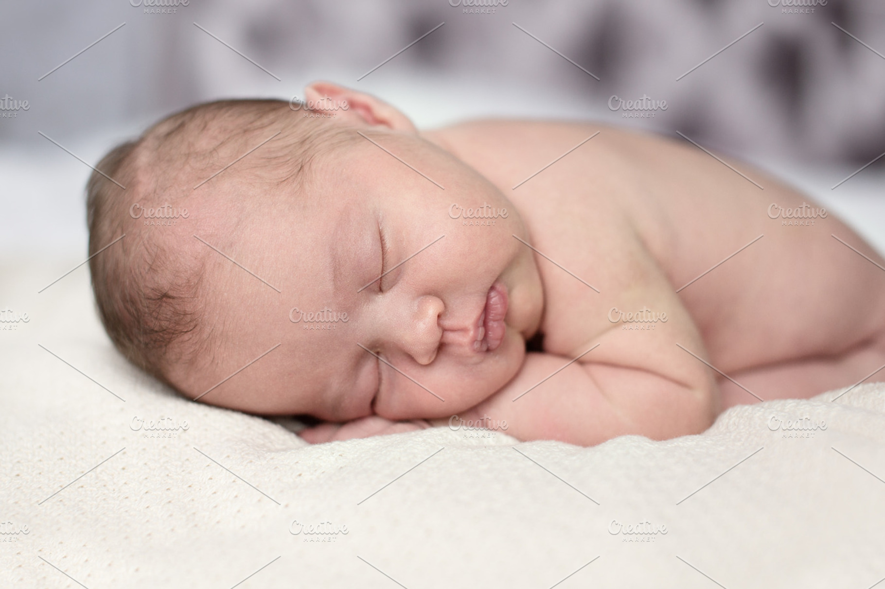 Newborn sleep on stomach featuring innocence, happy, and child HighQuality People Images