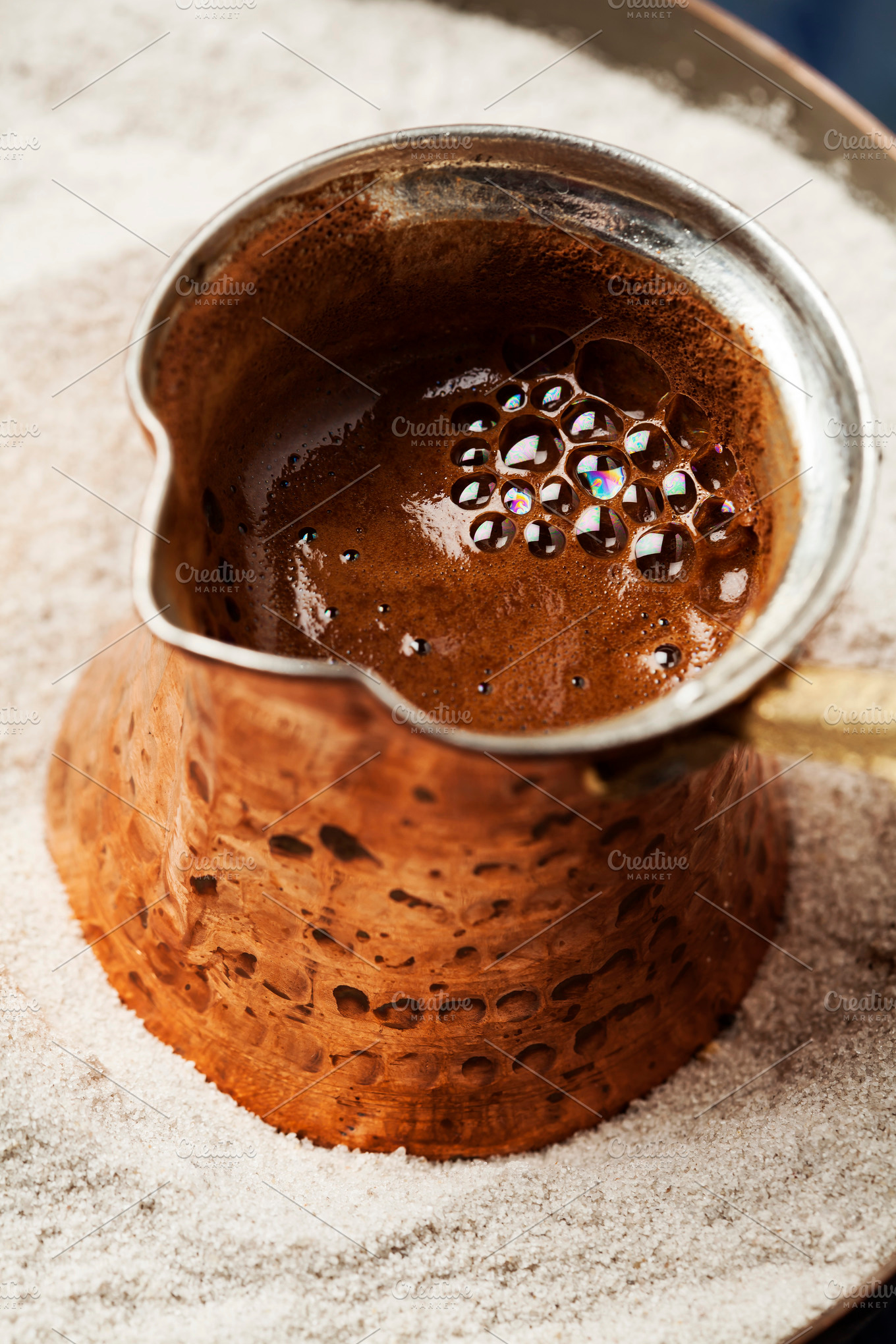 Turkish coffee made in cezve traditional coffee pot on sand stock photo