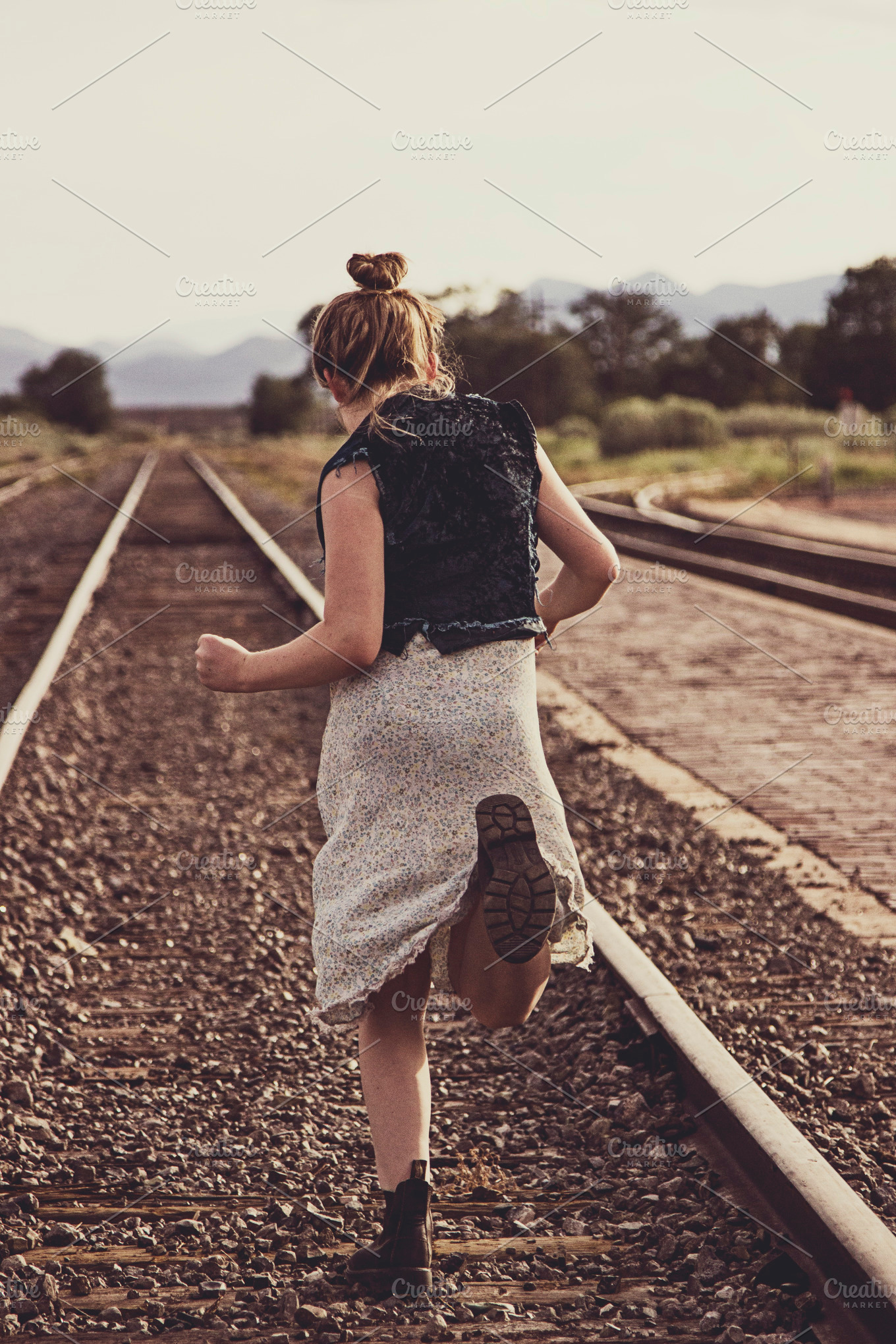 Girl running down traintracks featuring train, railroad tracks, and ...