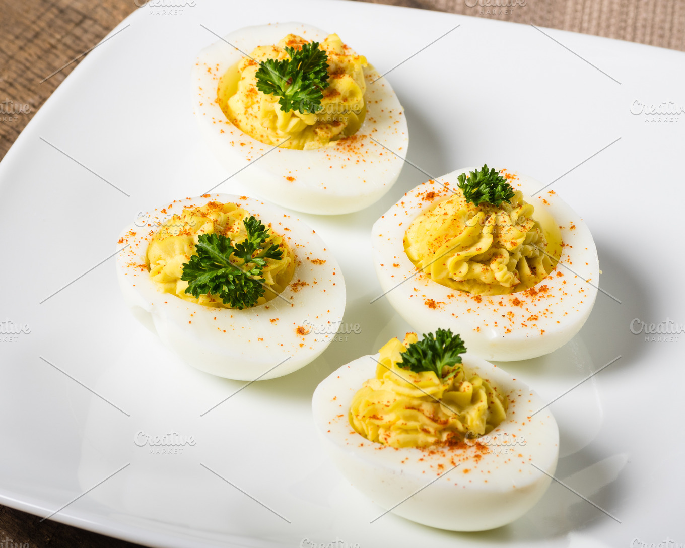 Deviled eggs garnished with parsley containing food, meal, and edible