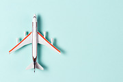 Toy plane on light blue background | Transportation Stock Photos