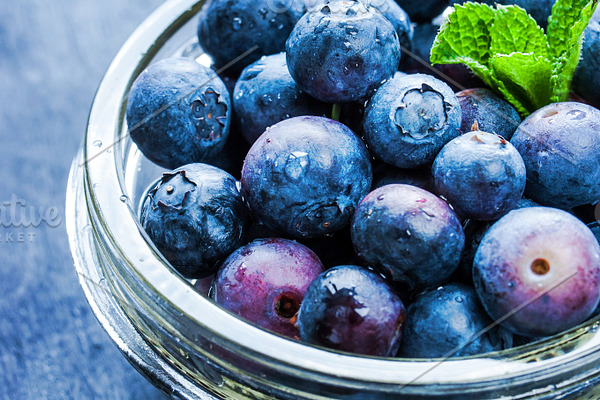 Blueberry with mint in a glass bowl featuring background, berry, and