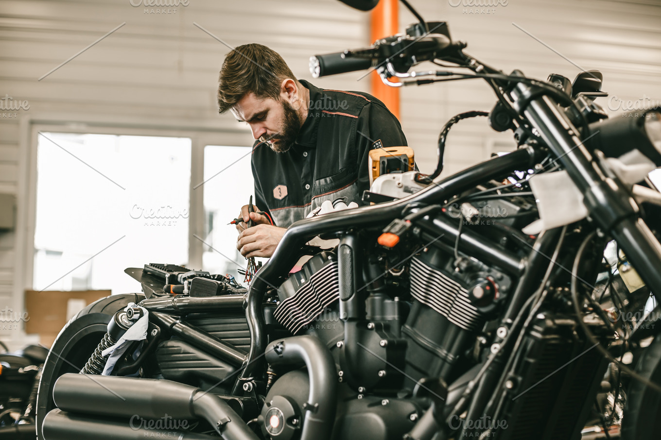 motorcycle-mechanic-repairing-electronics-sports-black-bike-containing