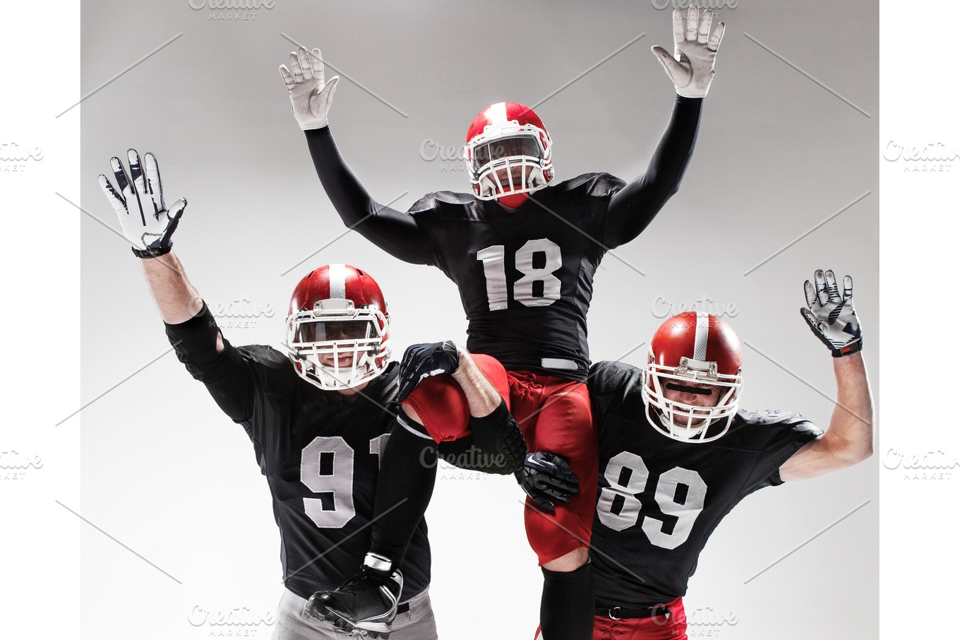 American football player posing with ball on black background Stock Photo  by master1305