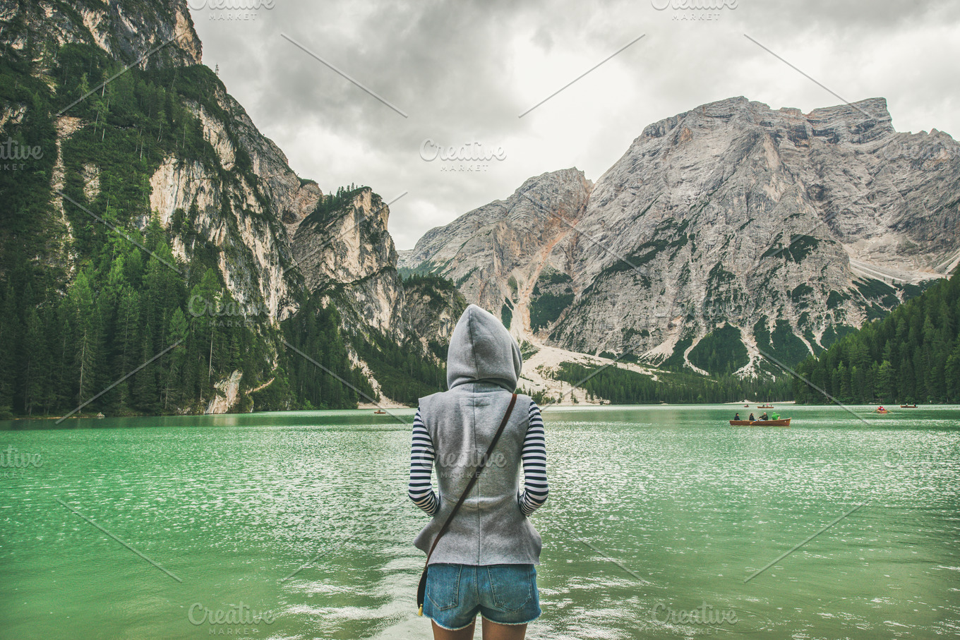 Traveller looking at Lago di Braies | People Images ~ Creative Market