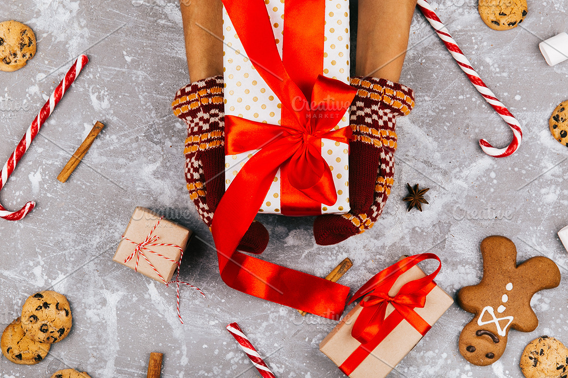 Hands with warm gloves hold box | Holiday Stock Photos ~ Creative Market