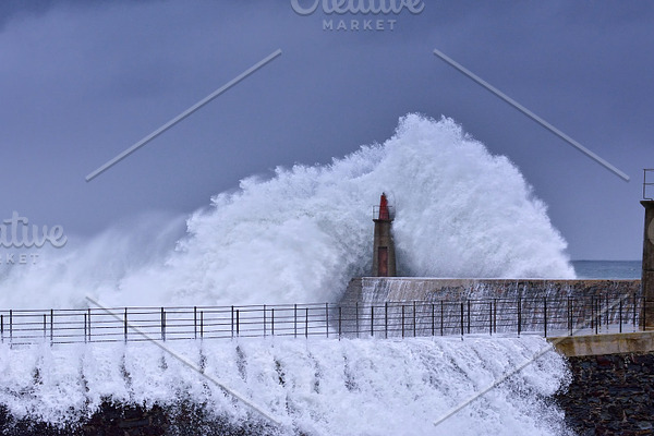 Stormy wave over old lighthouse containing lighthouse, storm, and ocean