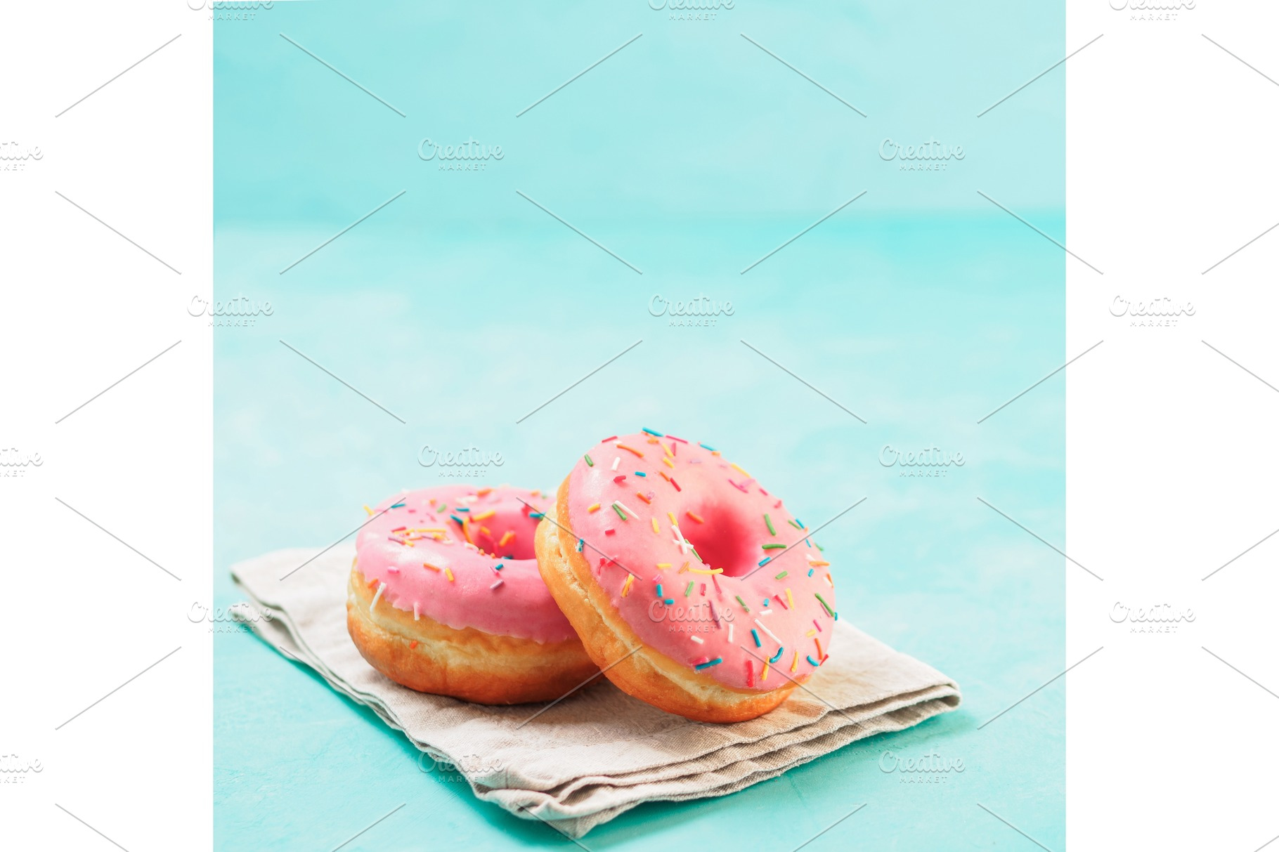 Pink donuts on blue background copy space featuring donut, dough, and