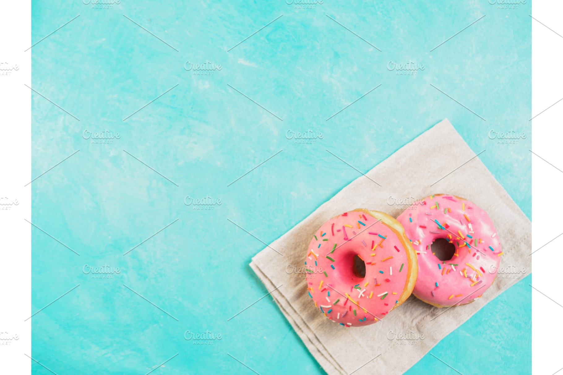 Pink donuts on blue background copy space top view containing donut