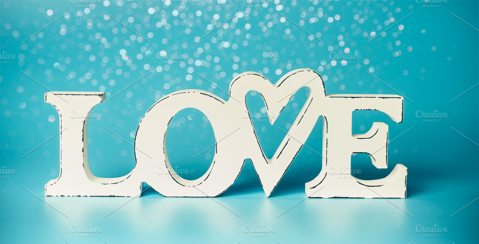 LOVE on turquoise blue background | Holiday Stock Photos ~ Creative Market