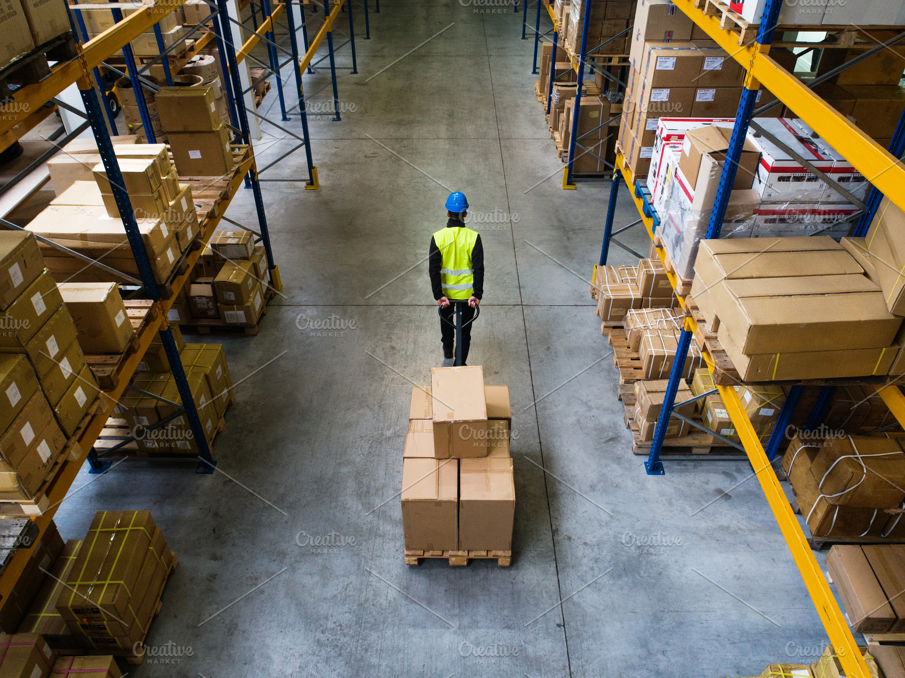 Download Male warehouse worker pulling a pallet truck. | Custom-Designed Graphics ~ Creative Market