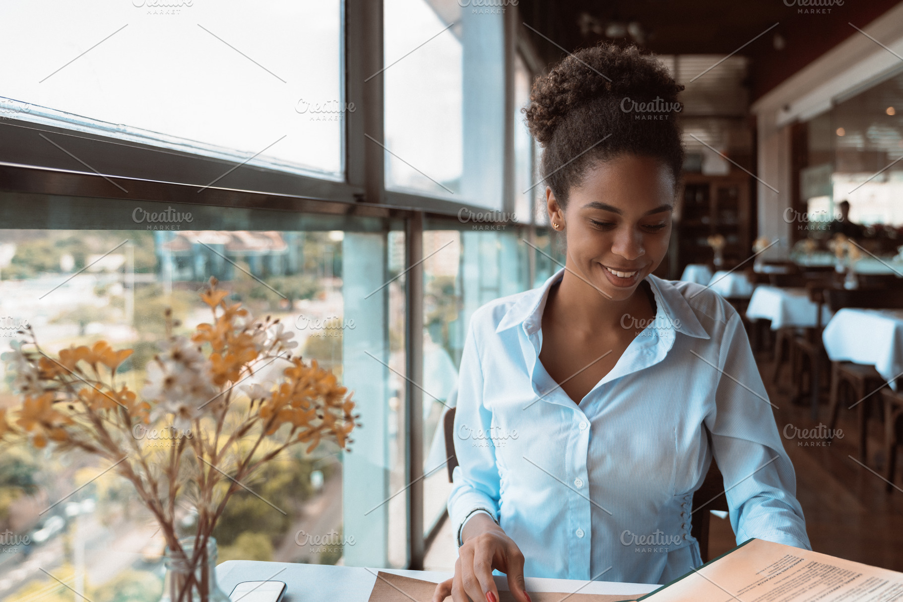 Girl in restaurant is using the menu | People Images ~ Creative Market