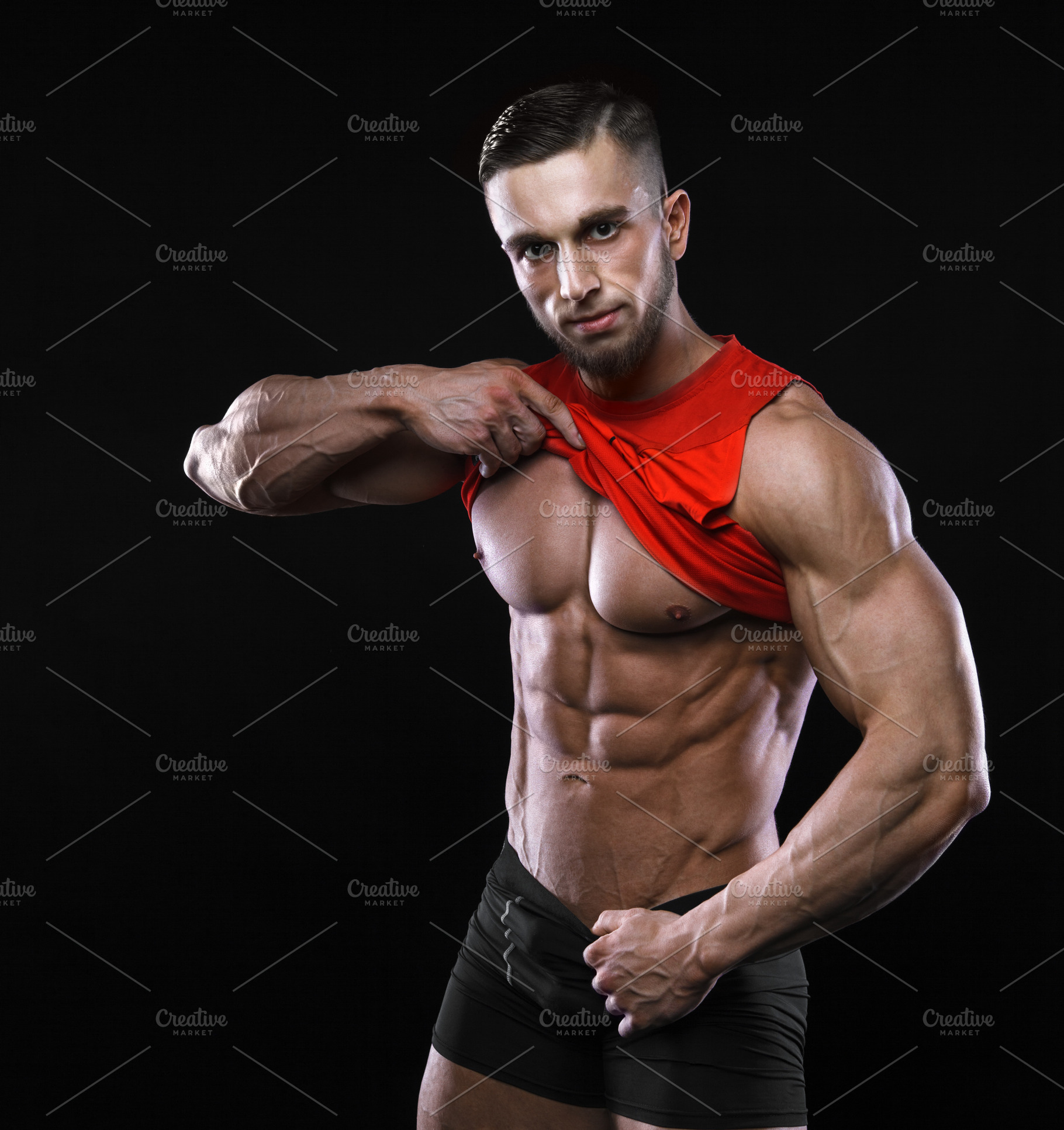 Cute Young Sports Man In Red Tshirt Shows Relief Abdominal Muscles In 