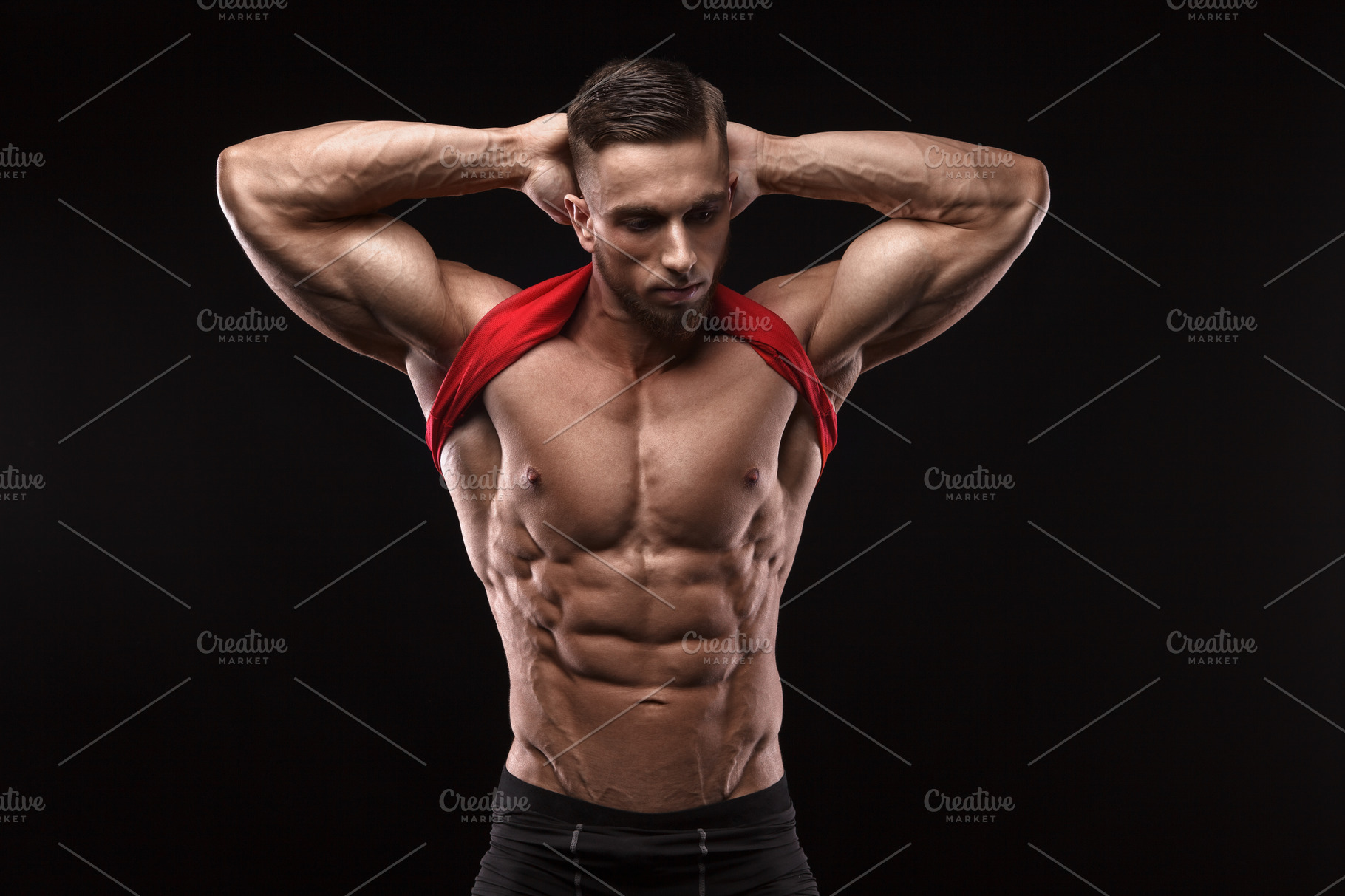 Cute young sports man in red t-shirt shows relief abdominal muscles in ...