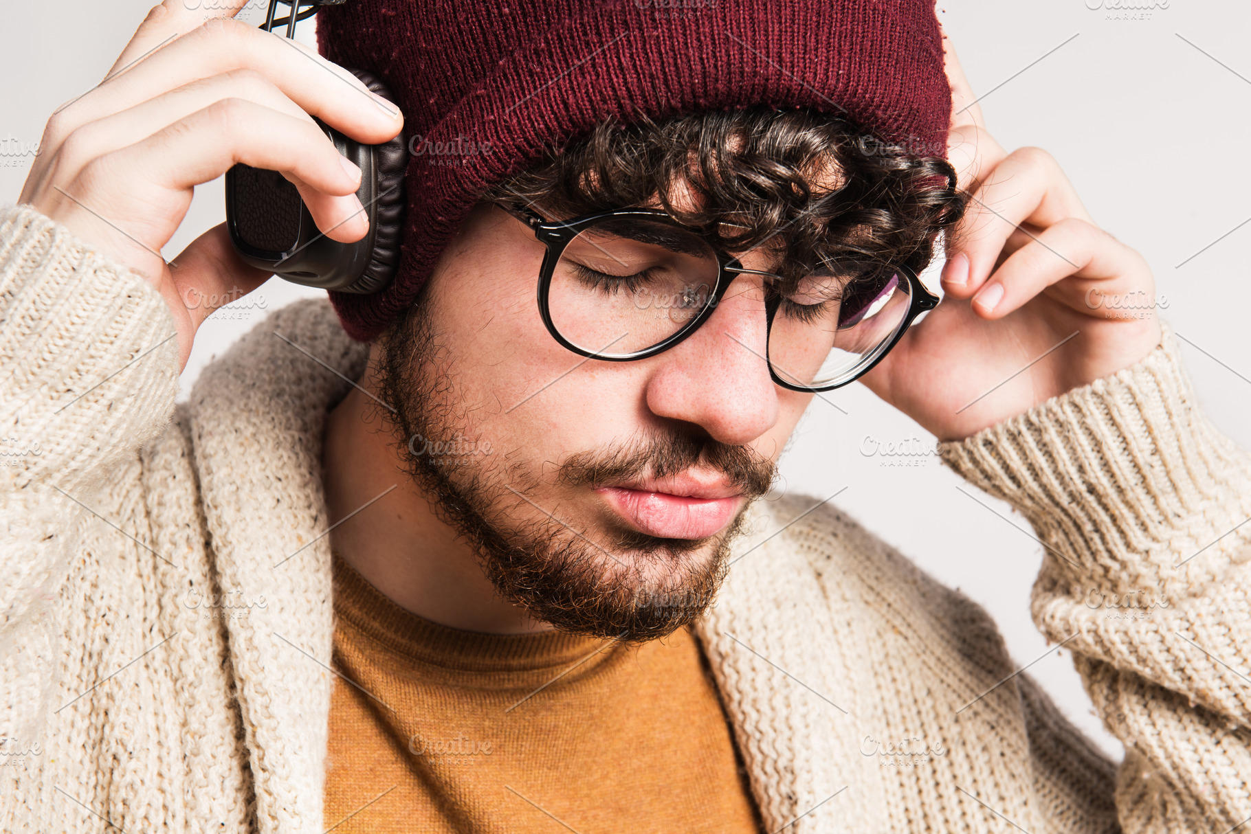 Portrait of a young man with hat and headphones in a studio stock photo ...