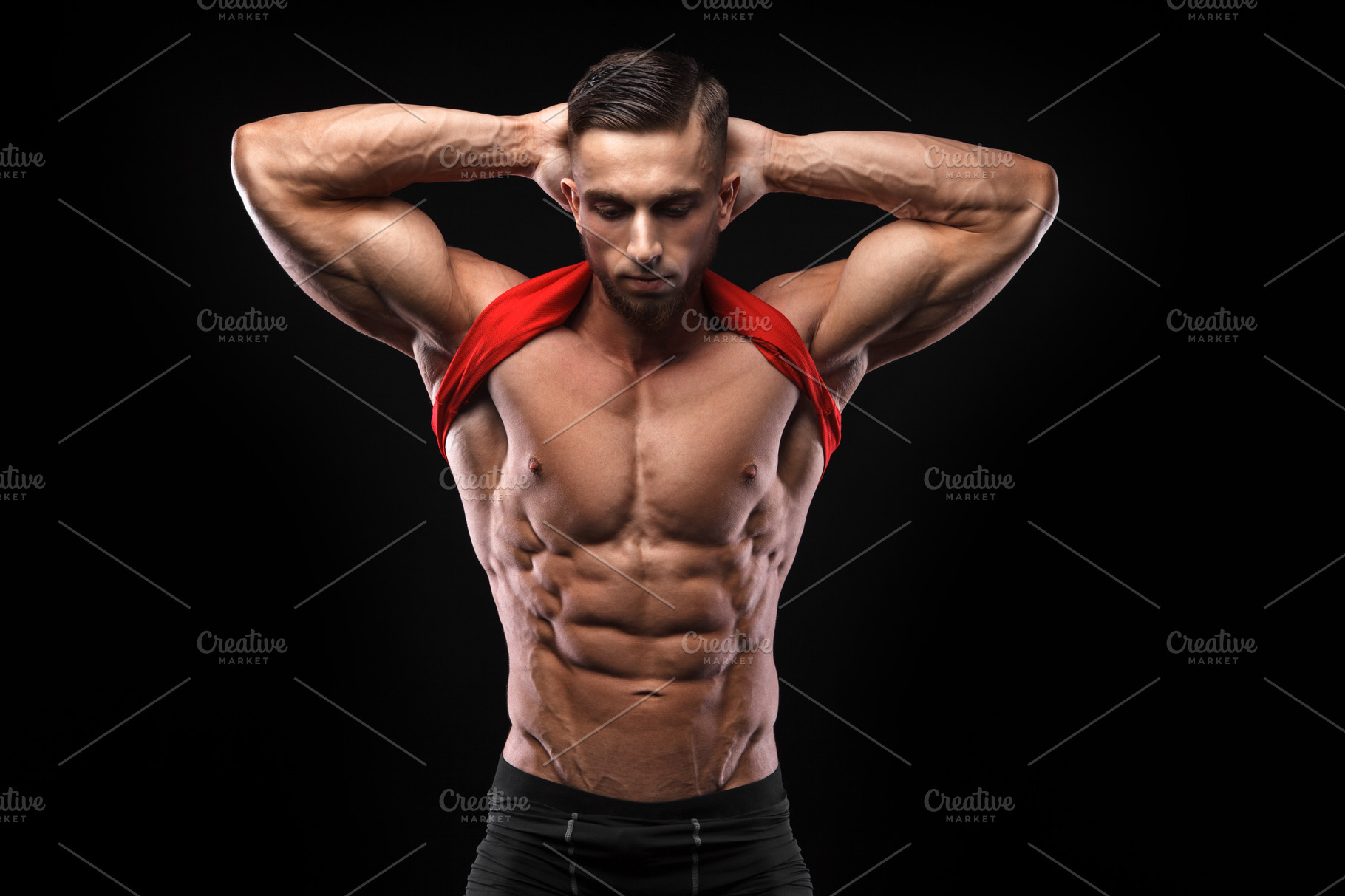 Cute young sports man in red tshirt shows relief abdominal muscles in ...