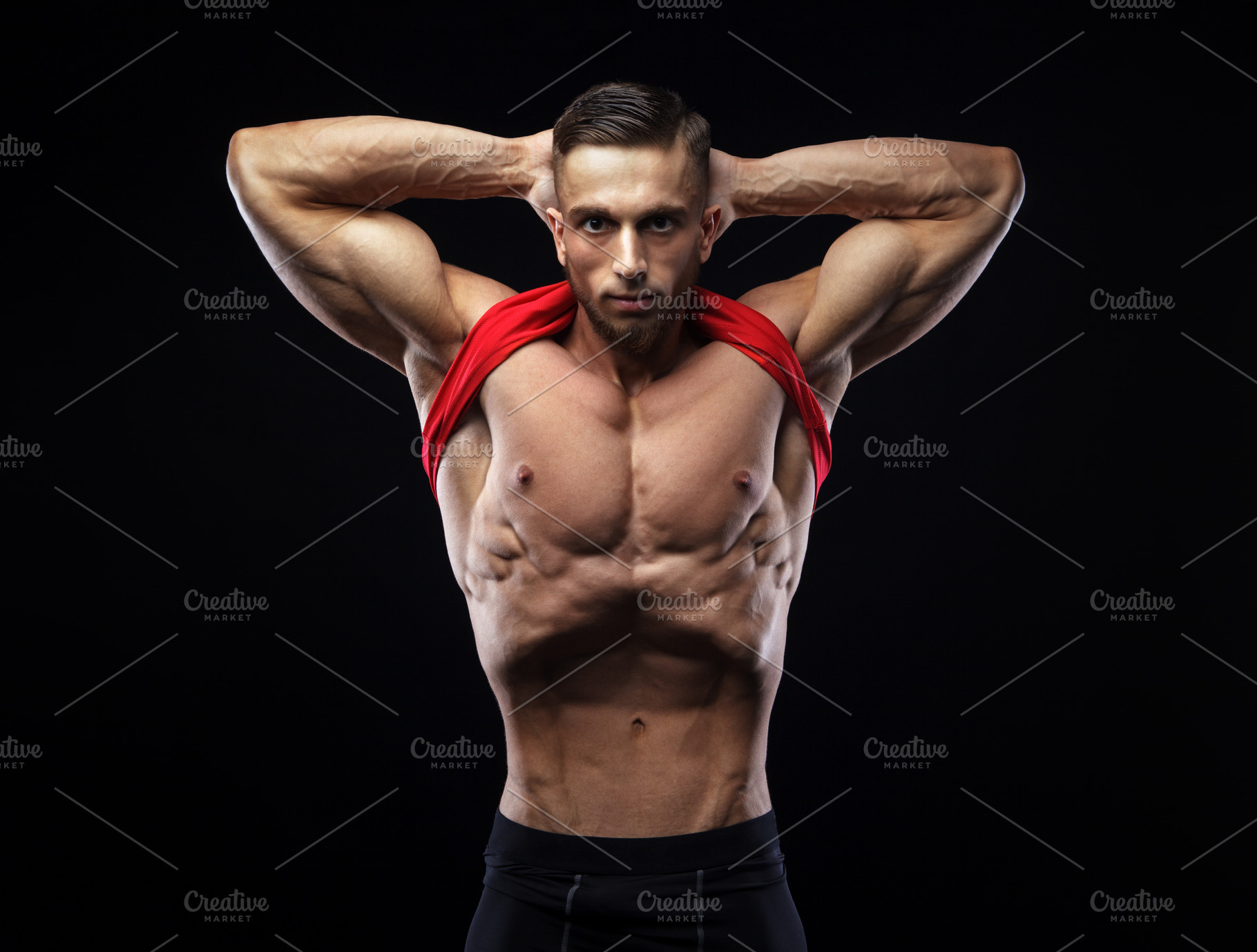 Cute young sports man in red t-shirt shows relief and vacuum abdominal ...