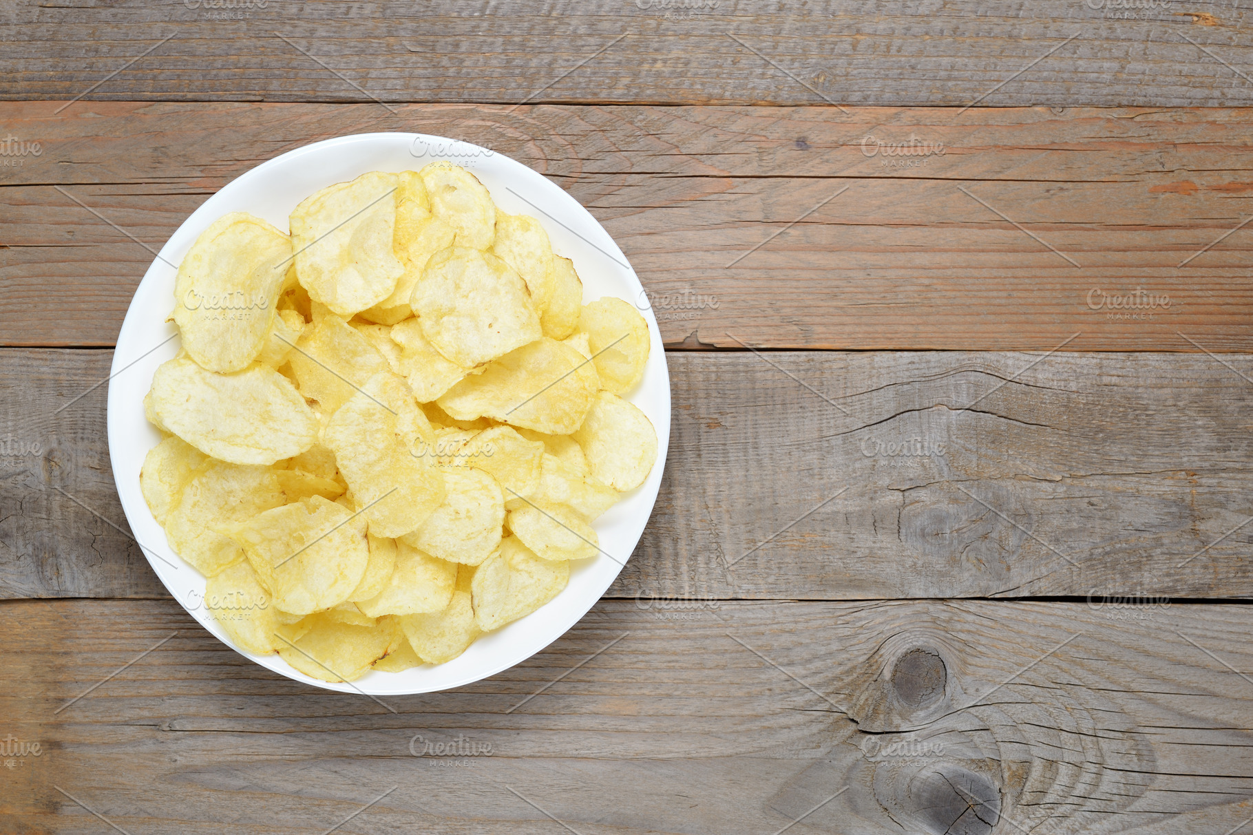 Potato chips in bowl on wooden table stock photo containing potato and ...