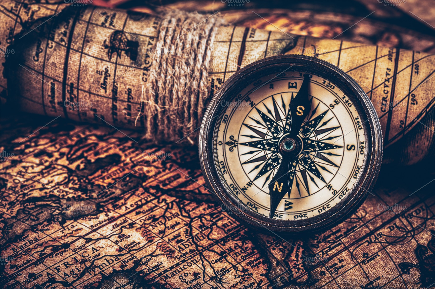 Old vintage compass on ancient map featuring compass, travel, and map