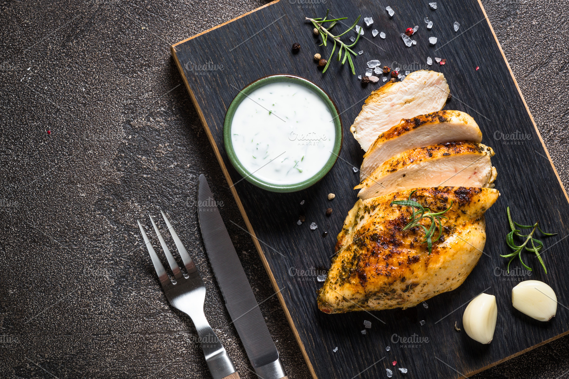 Grilled chicken fillet at wooden cutting board with vegetables Stock Photo  by Nadianb