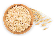 Oat spike with oat flakes in wooden containing oat, corn, and spiked ...