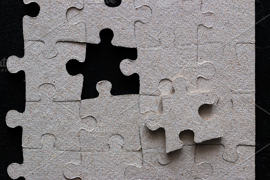 puzzle pieces on black background | High-Quality Business Images