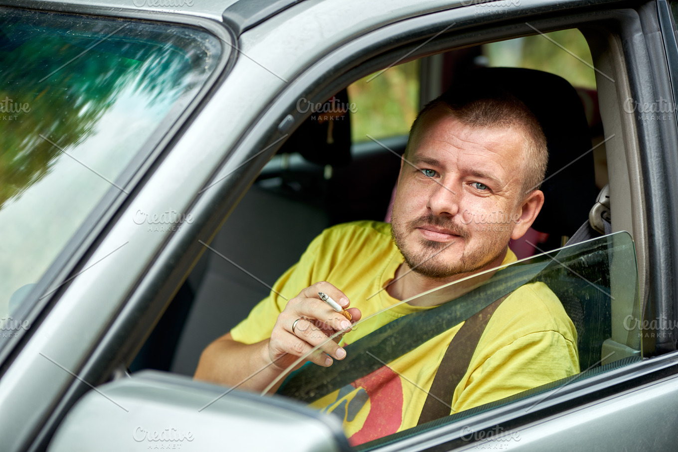 Man smoking in a car | High-Quality People Images ~ Creative Market