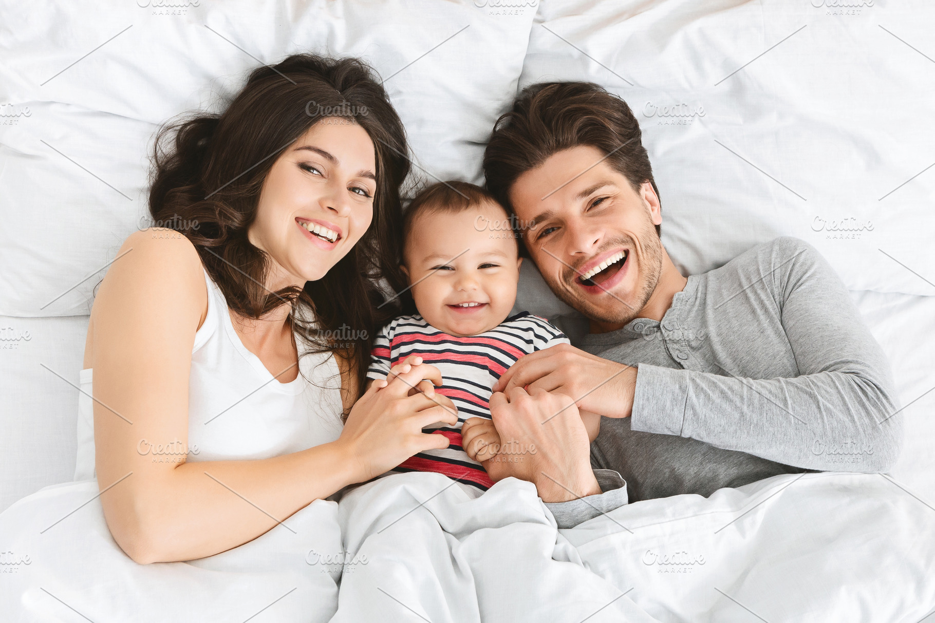 Happy Parents And Baby Lying In Bed High Quality Stock Photos Creative Market