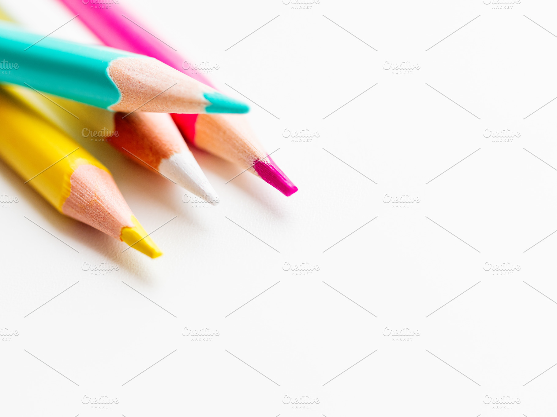 Colorful pencils on white background featuring pencil, stationery, and