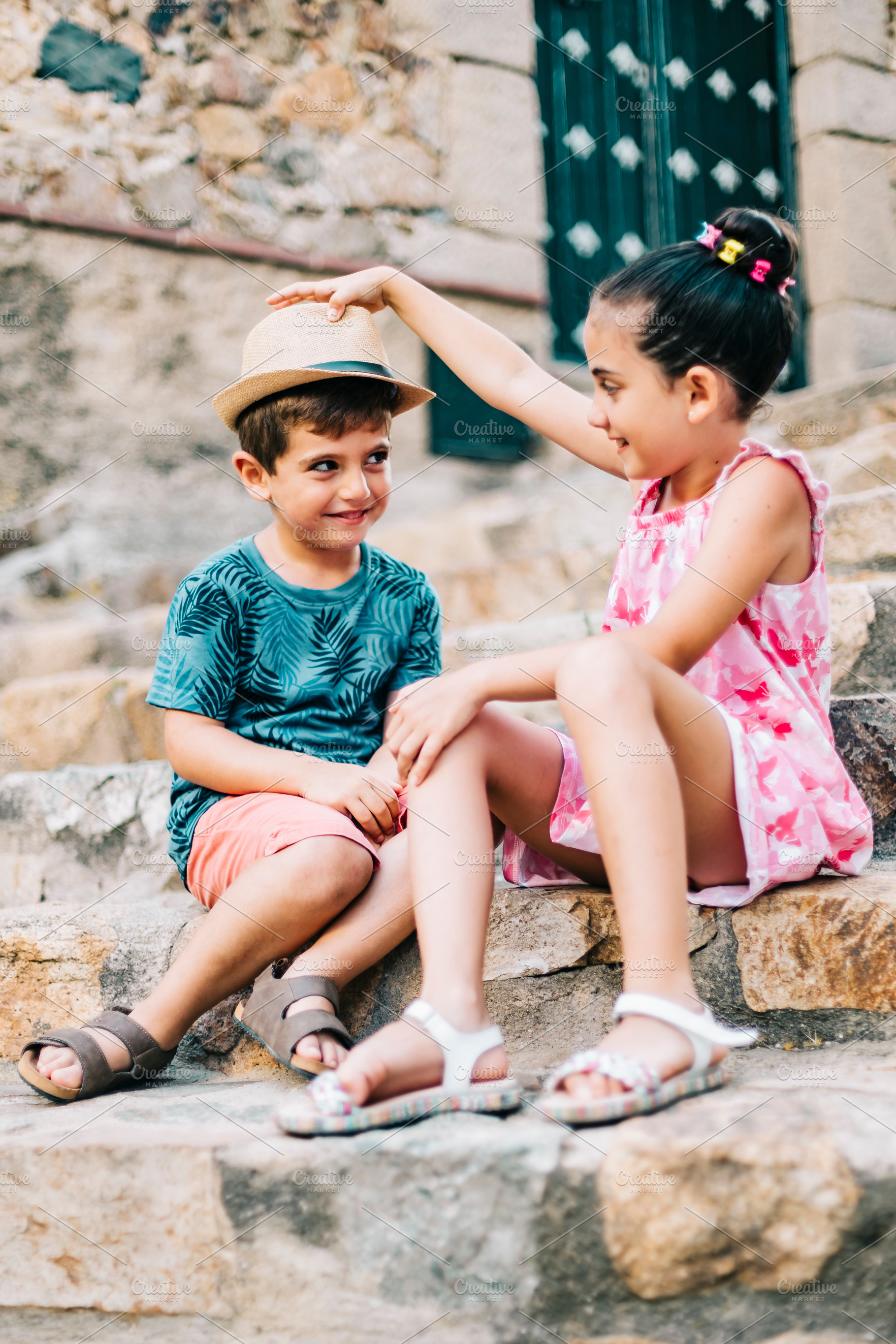 Two kids playing on a stairs of a ru containing active, adorable, and