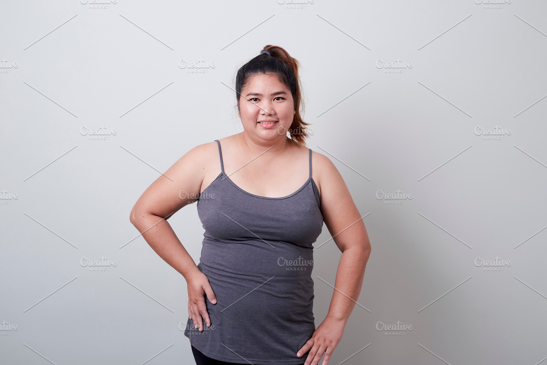 Unrecognizable black woman in underwear showing excessive fat on belly  Stock Photo by Prostock-studio