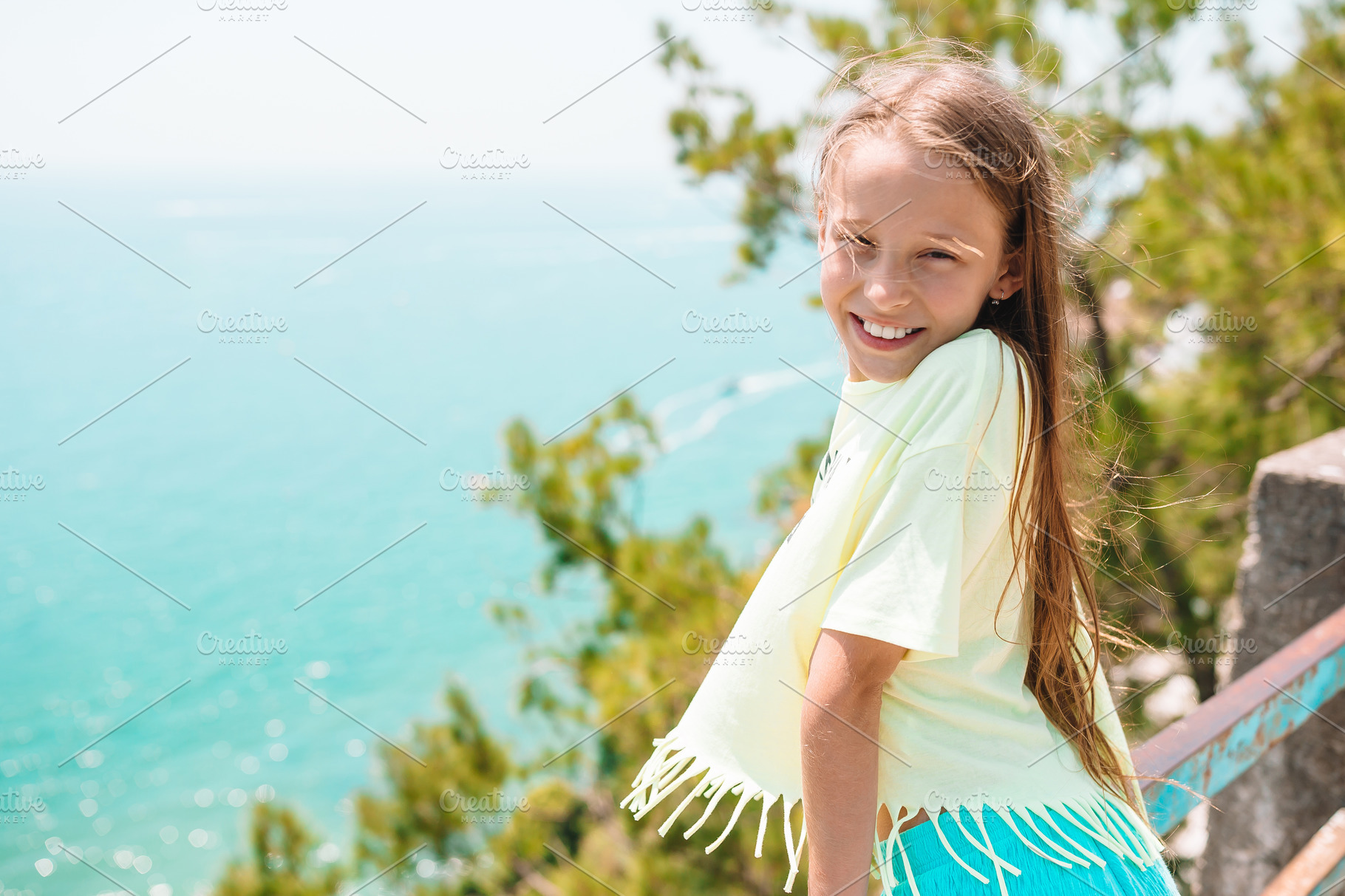 Young girl in background of mediterr featuring girl, vacation, and