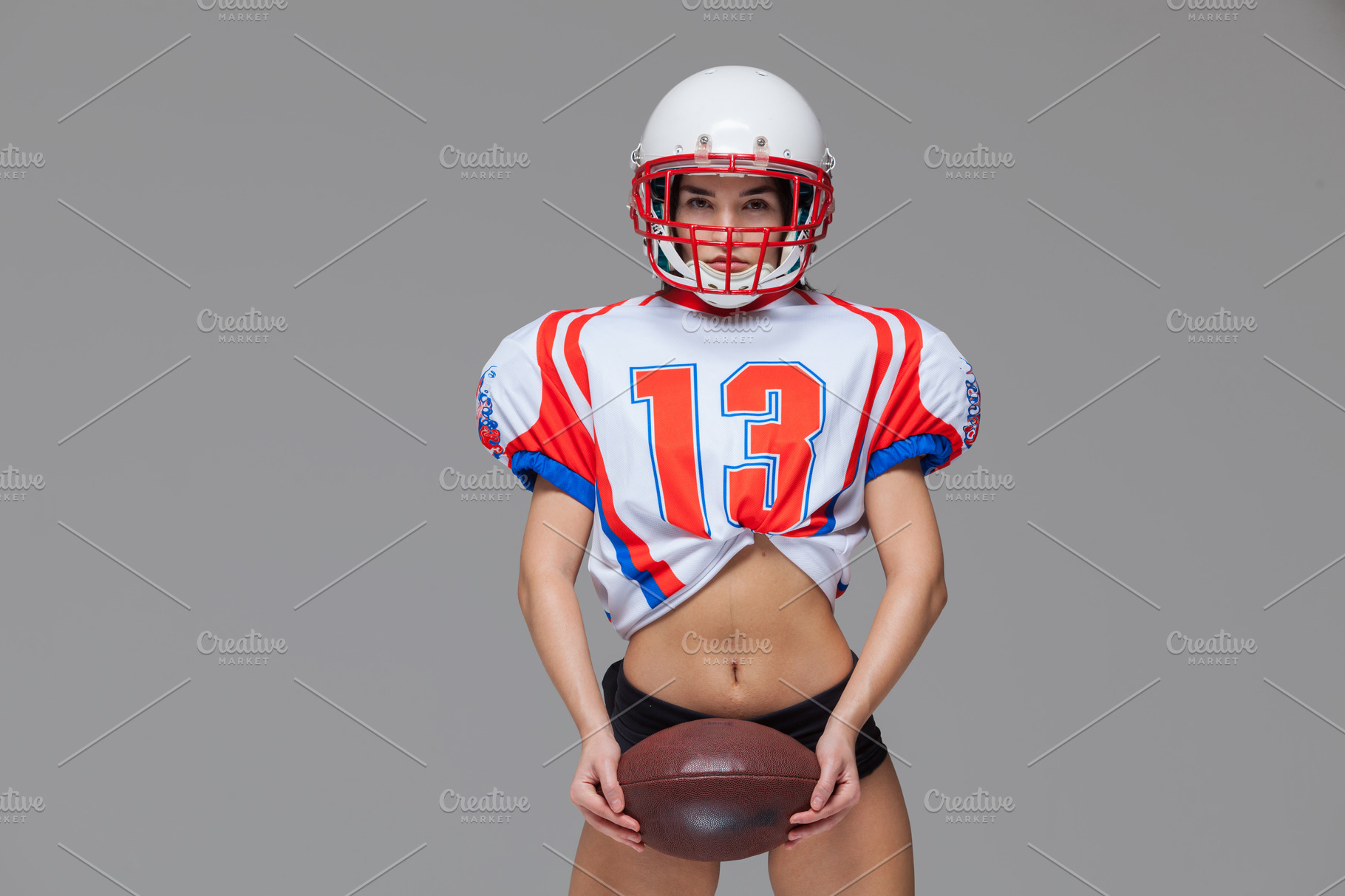 Attractive Female American Football Player In Uniform Stock Photo