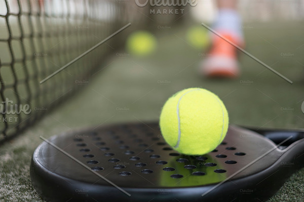 Paddle tennis racket and balls on co | High-Quality Sports Stock Photos