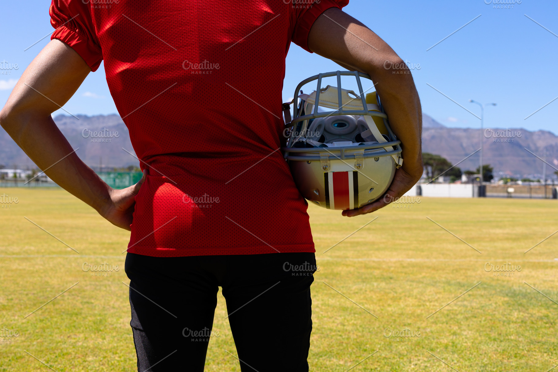 Football player carrying his helmet | Stock Photos ~ Creative Market