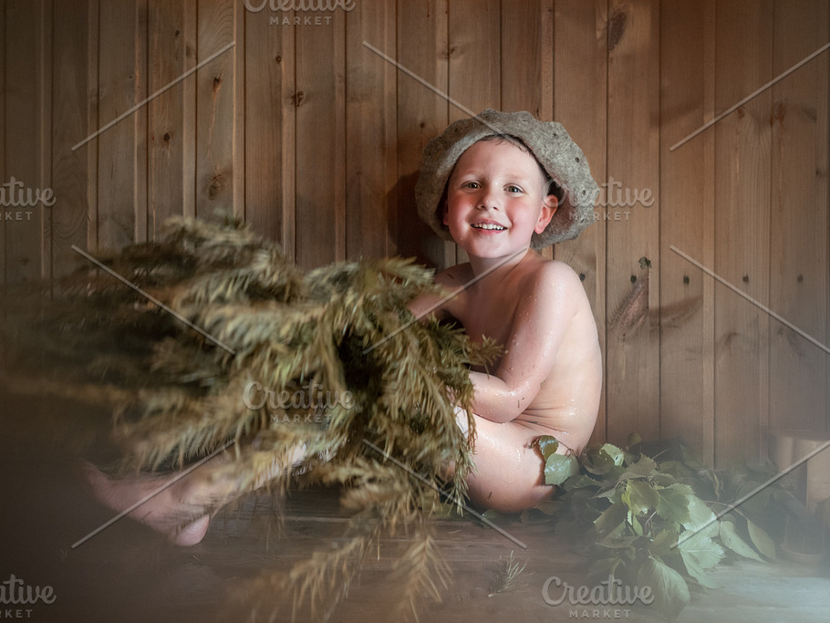 Beauty, healthcare. baby Boy relaxing in the sauna Toddler with broom and  hat in russian sauna or bath Stock Photo